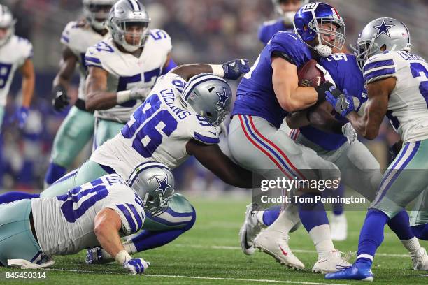 Sean Lee and Maliek Collins of the Dallas Cowboys try to stop the run by Rhett Ellison of the New York Giants in the second half of a game at AT&T...