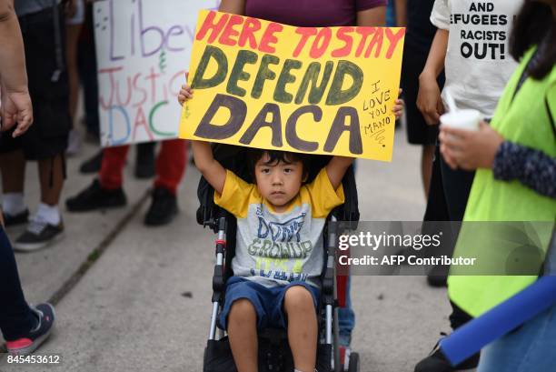 Young boy holds a sign during a protest September 10, 2017 in Los Angeles, California against efforts by the Trump administration to phase out DACA ,...