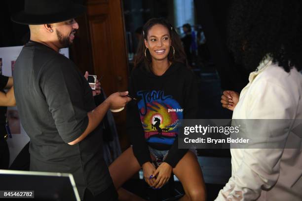 Joan Smalls prepares backstage at the FENTY PUMA by Rihanna Spring/Summer 2018 Collection at Park Avenue Armory on September 10, 2017 in New York...