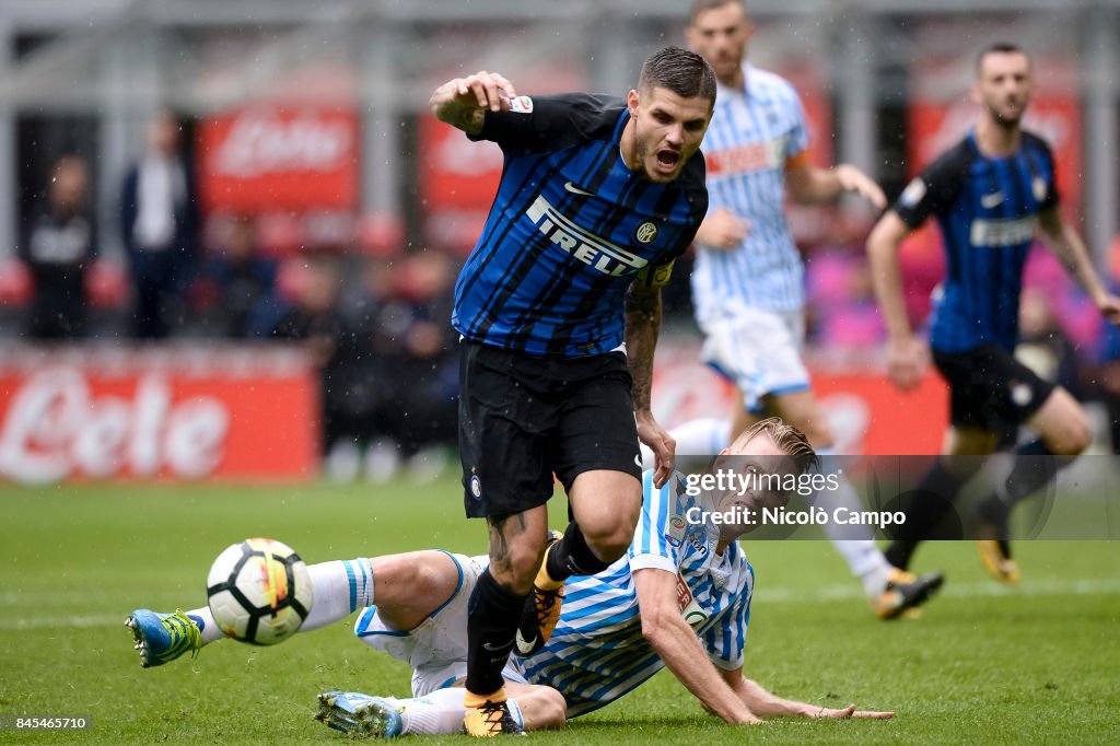 Mauro Icardi (L) of FC Internazionale is tackled by Bartosz...