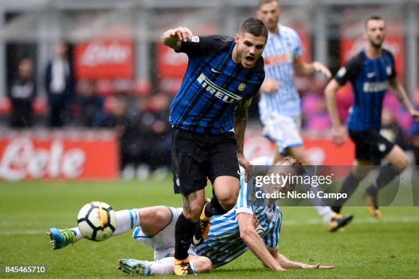 Mauro Icardi of FC Internazionale is tackled by Bartosz Salamon of Spal during the Serie A football match between FC Internazionale and Spal. FC...