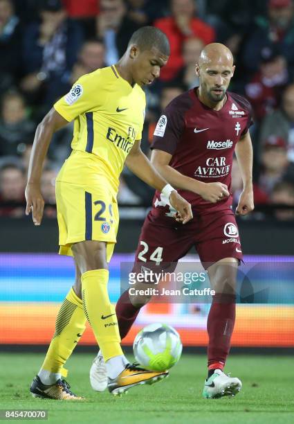 Kylian Mbappe of PSG, Renaud Cohade of FC Metz during the French Ligue 1 match between FC Metz and Paris Saint Germain at Stade Saint-Symphorien on...