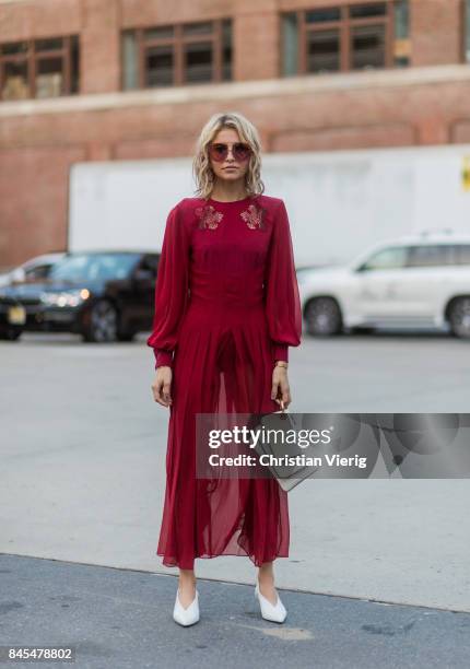 Caroline Daur wearing a red dress seen in the streets of Manhattan outside Prabal Gurung during New York Fashion Week on September 10, 2017 in New...