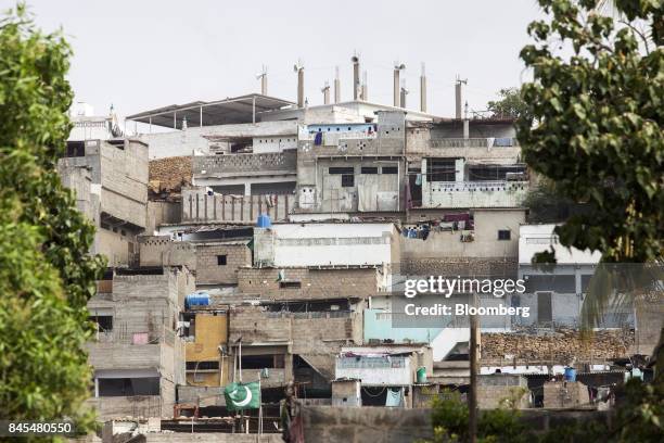 Slum housing stands on a hill in the Orangi town area of Karachi, Pakistan, on Tuesday, Aug. 222, 2017. The murder of Orangi Pilot Project director...
