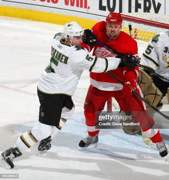 Matt Niskanen of the Dallas Stars crosschecks Tomas Holmstrom of the Detroit Red Wings during their NHL game at Joe Louis Arena January 29, 2009 in...