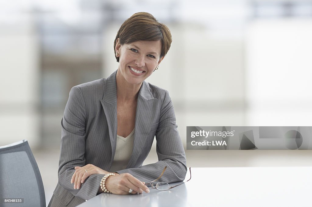 Businesswoman Sitting at Conference Table