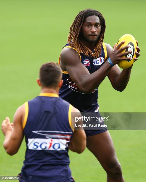 Nic Naitanui works on works on a handball drill during a West Coast Eagles AFL training session at Domain Stadium on September 11, 2017 in Perth,...