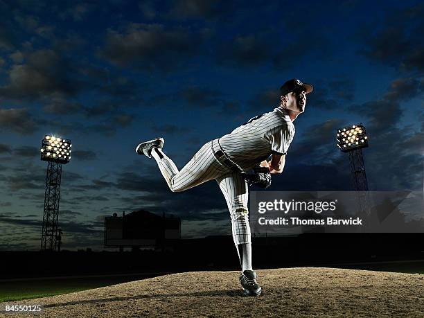 baseball player pitching off mound - throw off balance stock-fotos und bilder