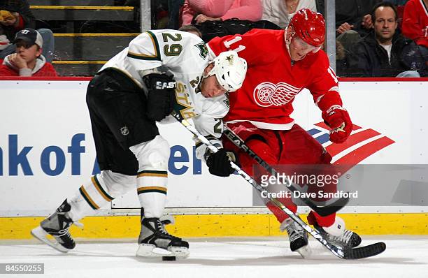 Dan Cleary of the Detroit Red Wings battles for the puck with Steve Ott of the Dallas Stars during their NHL game at Joe Louis Arena January 29, 2009...