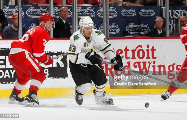 Brian Rafalski of the Detroit Red Wings looks on as Stephane Robidas of the Dallas Stars carries the puck during their NHL game at Joe Louis Arena...