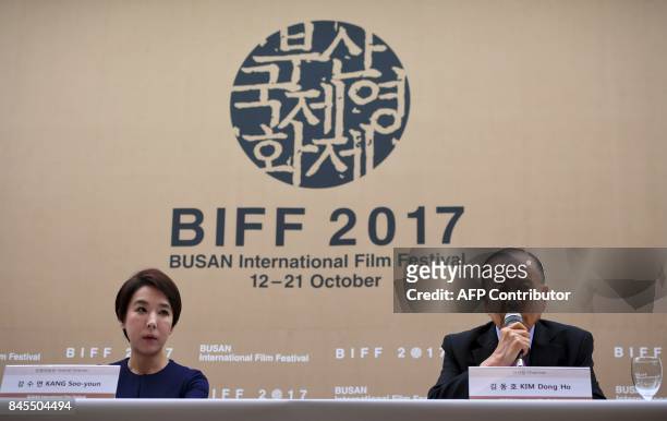 Kang Soo-Youn , director of the Busan International Film Festival , and the festival chirman Kim Dong-Ho attend at a press conference in Seoul on...