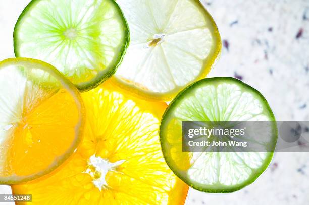 citrus slices on a marble stone background - sour fruit stock pictures, royalty-free photos & images