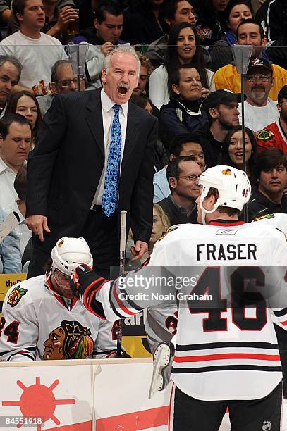 Chicago Blackhawks head coach Joel Quenneville yells out as the Blackhawks' Colin Fraser skates back to the bench during the game against the Los...