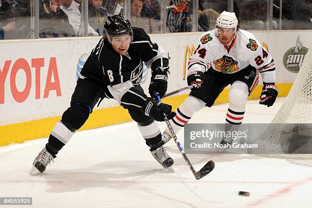 Drew Doughty of the Los Angeles Kings handles the puck as Martin Havlat of the Chicago Blackhawks follows on the play on January 29, 2009 at Staples...