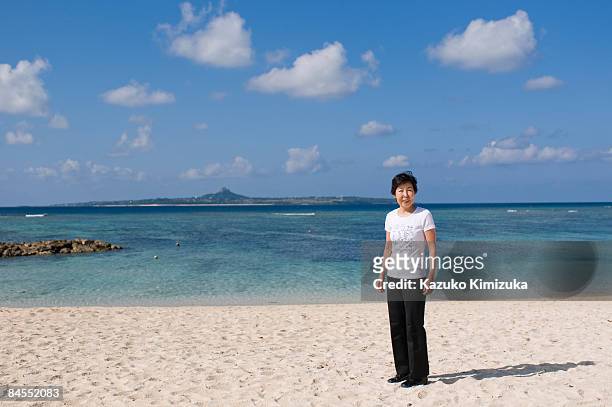 senior woman on the beach,smiling - kazuko kimizuka stock pictures, royalty-free photos & images