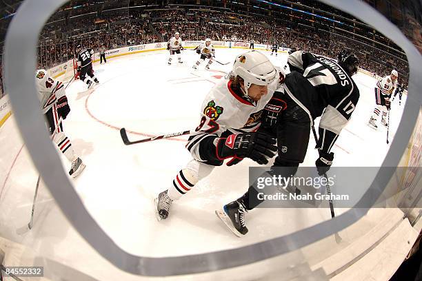 Adam Burish of the Chicago Blackhawks checks Wayne Simmonds of the Los Angeles Kings during the game on January 29, 2009 at Staples Center in Los...