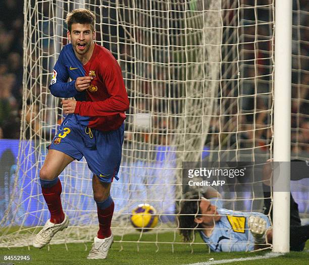 Barcelonas's Gerard Pique celebrates beating RCD Espanyol's goalie Cristian Alvarez during the King's Cup football match at the New Camp Stadium on...