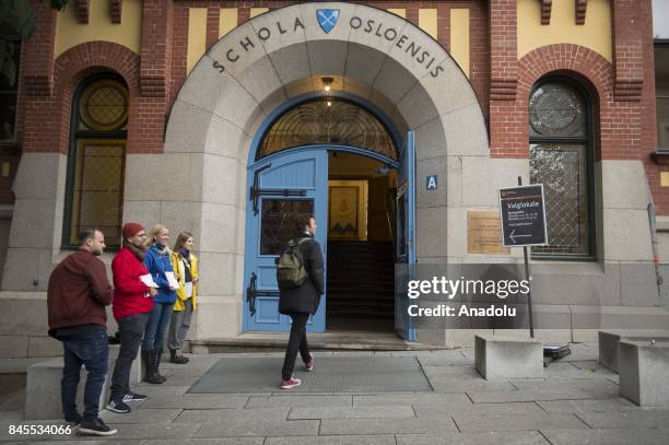 Norwegian voters arrive at the poll station to cast their votes during the parliamentary elections at Oslo Katedral School in Oslo, Norway on...