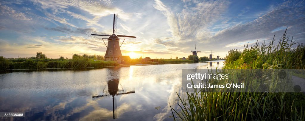 Windmills and river at sunrise panoramic, Kinderdijk, Netherlands