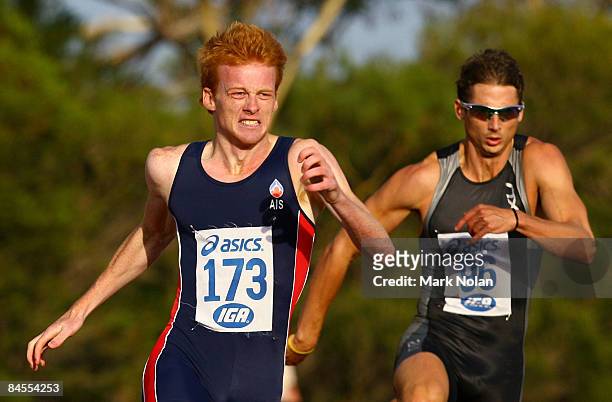 Tristan Thomas of the AIS leads the mens 400 metres hurdles ahead of Brendan Cole of the ACT during the Graeme Briggs Classic held at Domain...