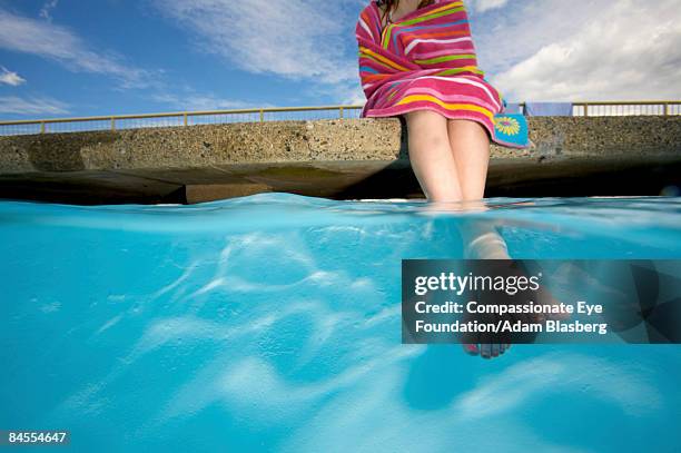 girl sitting beside pool, feet in water - ankle deep in water fotografías e imágenes de stock