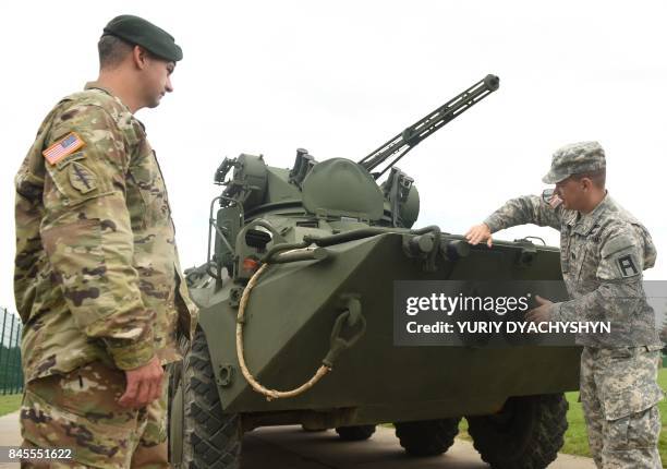 Soldiers examin an Ukrainian APC following the opening ceremony of "Rapid Trident-2017", international military exercises, at the Yavoriv shooting...