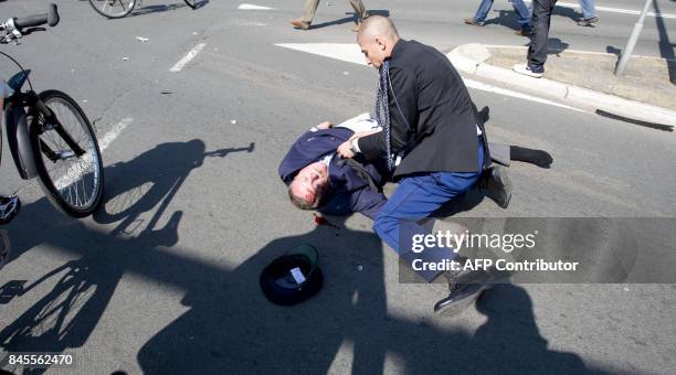 Victim is helped after a car crashed into the crowd waiting for the visit of the royal family in Apeldoorn on April 30, 2009. Dutch Queen Beatrix and...