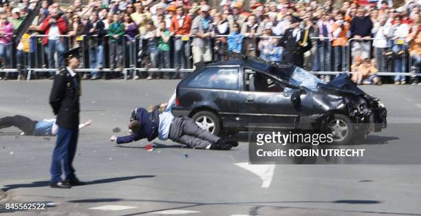 Car crashes into the crowd waiting for the visit of the royal family in Apeldoorn on April 30, 2009. Dutch Queen Beatrix and royal family members...