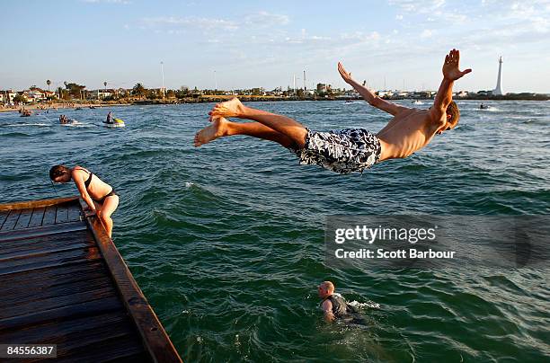 People dive into the ocean from the pier at St Kilda beach on January 30, 2009 in Melbourne, Australia. Melbourne temperatures were expected to reach...