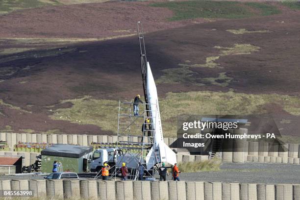 Technicians from Starchaser Industries prepare Britain's biggest reusable rocket Skybolt 2, which stands 8.3m tall, prior to its launch by the...