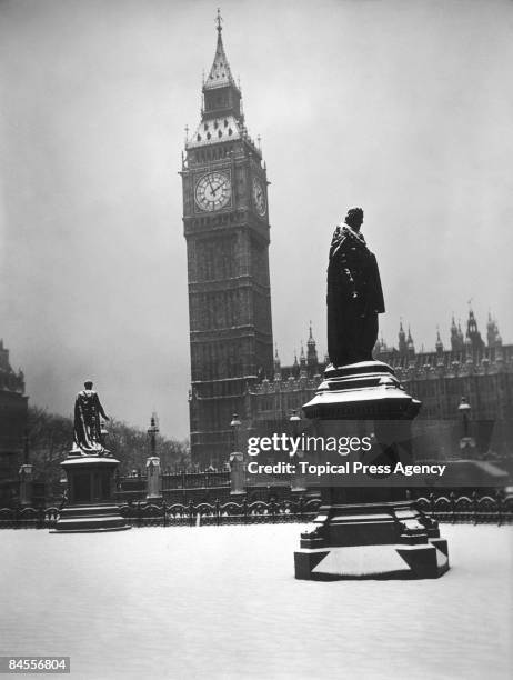 The statue of Lord Beaconsfield in front of the Houses of Parliament and Big Ben, Parliament Square, London, 24th December 1938.