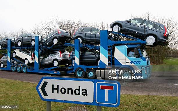 Transporter loaded with Honda cars leaves the Honda car factory in Swindon, southwest England, on January 30, 2009. Workers at Honda's British...