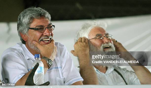 President Fernando Lugo of Paraguay and Brazilian theologian Leonardo Boff laugh during a conference with members of Brazil's Landless Movement and...