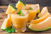 The juice of melon with mint in a glass jar on the table.Hami melon
