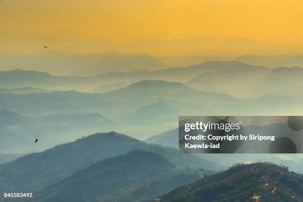 beautiful aerial view of himalayas mountain and hills with morning fog during sunrise in nagarkot, nepal. - himalayas sunrise stock pictures, royalty-free photos & images