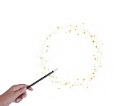 Magic wand in hand, circle or ring of golden stars and stardust isoated on white.