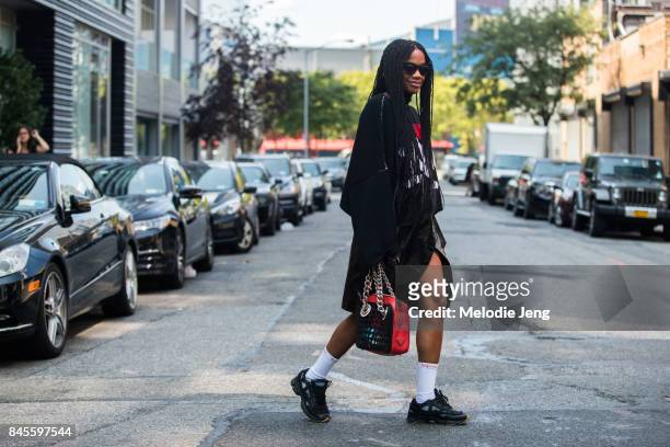 Jan-Michael Quammie wears a Raf Simons " <3 New York" sweater, Prada bag, Supreme socks, and Raf Simons sneakers on September 10, 2017 in New York...