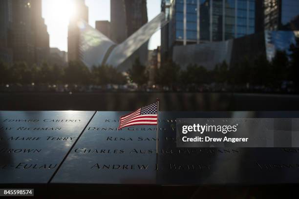 An American flag is left at the North pool memorial site before a commemoration ceremony for the victims of the September 11 terrorist attacks at the...