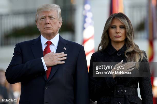 President Donald Trump and first lady Melania Trump, observe a moment of silence on the South Lawn for the September 11 terrorist attacks September...