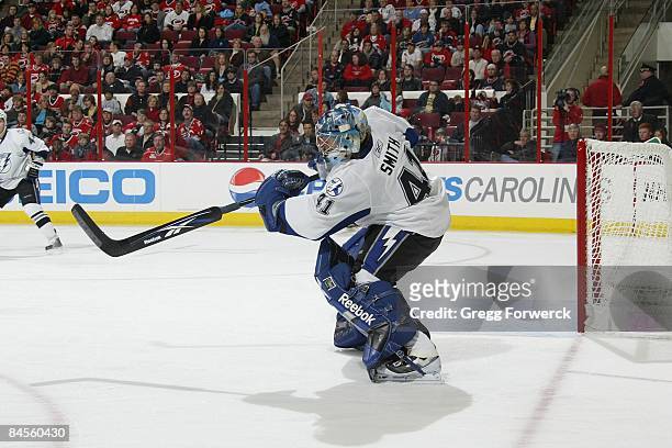 Mike Smith of the Tampa Bay Lightning clears the puck during a NHL game against the Carolina Hurricanes on January 29, 2009 at RBC Center in Raleigh,...