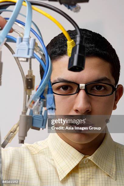 nerd holding up computer cords - computer nerd fotografías e imágenes de stock