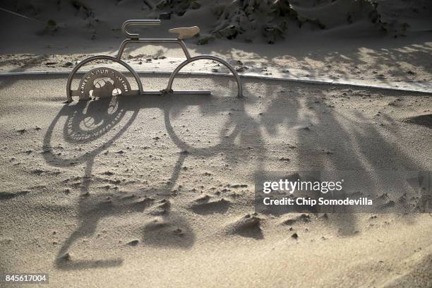 Bicycle rack is half buried in blown sand at Fort Lauderdale Beach the day after Hurricane Irma slammed into the state September 11, 2017 in Fort...