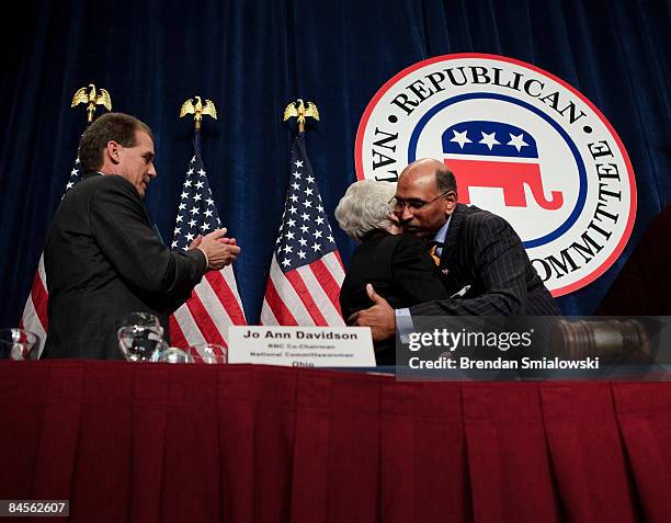 Republican National Committee's General Counsel Blake Hall watches as Michael S. Steele hugs RNC Co-Chairman Jo Ann Davidson after he was elected...