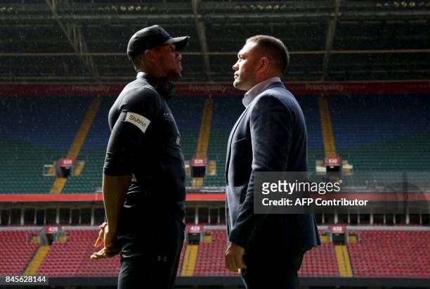 Britain's Anthony Joshua and Bulgaria's Kubrat Pulev stand on the pitch at the Principality Stadium in Cardiff on September 11, 2017 during a...
