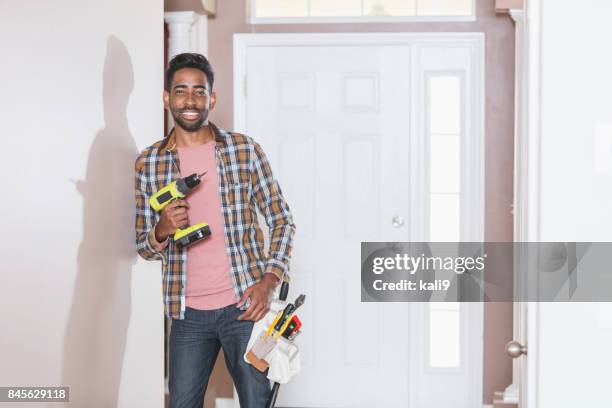 handyman doing home repairs - handyman smiling imagens e fotografias de stock