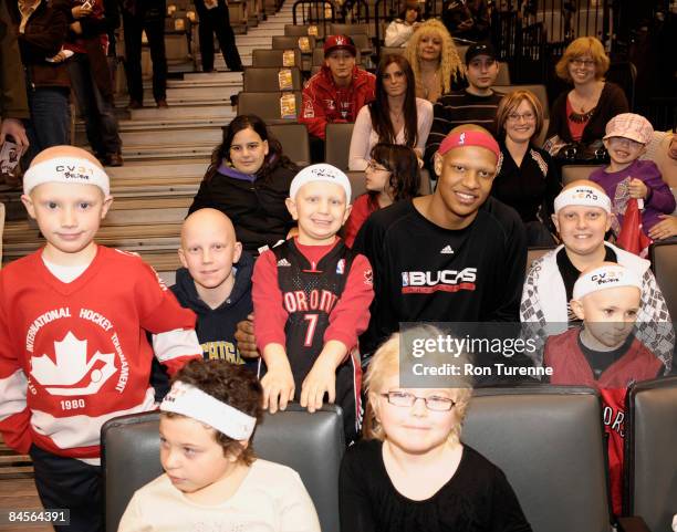 Charlie Villanueva of the Milwaukee Bucks greets and poses with fans in part of the Charlie Villaneuva Foundation prior to a game against the...
