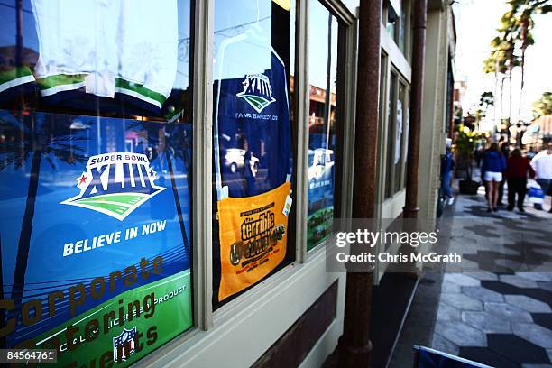 People walk past a shop window displaying Super Bowl XLIII merchandise on January 30, 2009 in Tampa, Florida. NFL fans from across the country are...