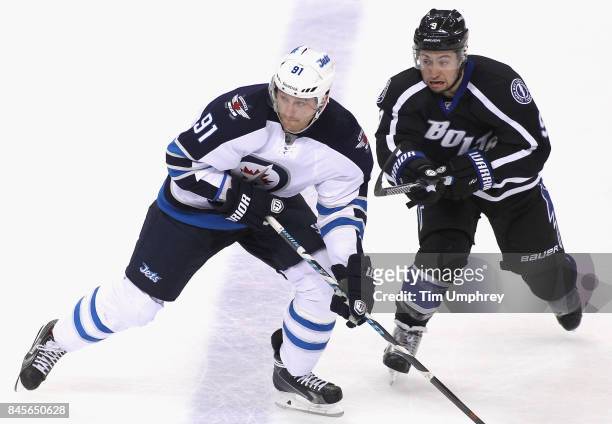 Jiri Tlusty of the Winnipeg Jets plays in the game against Tyler Johnson of the Tampa Bay Lightning at Amalie Arena on March 14, 2015 in Tampa,...