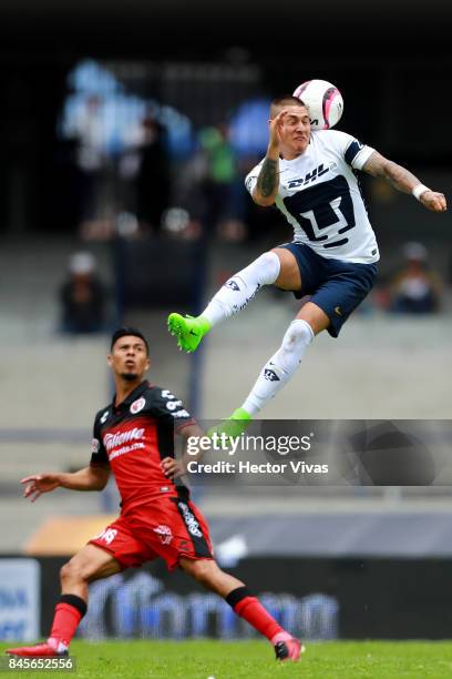 Nicolas Castillo of Pumas heads for the ball with Michael Orozco of Tijuana during the 8th round match between Pumas UNAM and Tijuana as part of the...