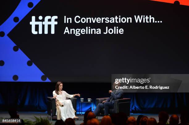 Producer/filmmaker Rithy Panh and Director Angelina Jolie speak onstage at the In Conversation With... Angelina Jolie event during the 2017 Toronto...